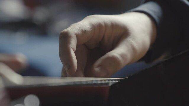 Playing acustic Guitar closeup. People and musical education concept.
