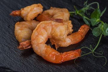 Fried shrimp on a black tray
