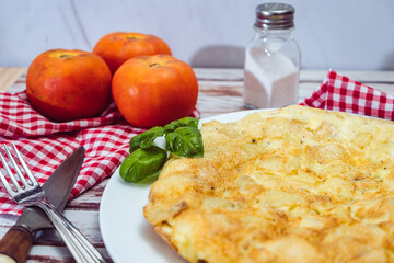 high view of a Spanish potato omelette on a wooden table.