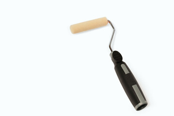 Paint roller with black handle. Painting surfaces with a paint roller.