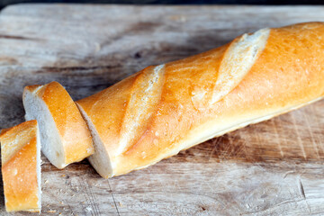 wheat baguette cut into pieces on a cutting board