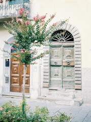 Fototapeta na wymiar Building with beautiful authentic doors. Lucca, Tuscany, Italy. Typical Italian street.