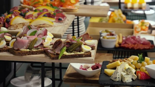 Catering banquet table with snack canape in restaurant or hotel. Catering service, business buffet, food set in event celebration corporate, birthday, party or wedding