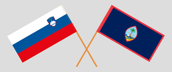 Crossed flags of Slovenia and Guam. Official colors. Correct proportion