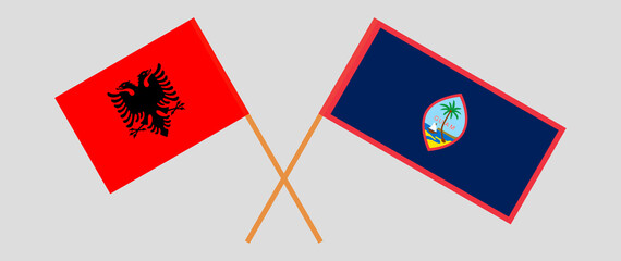 Crossed flags of Albania and Guam. Official colors. Correct proportion
