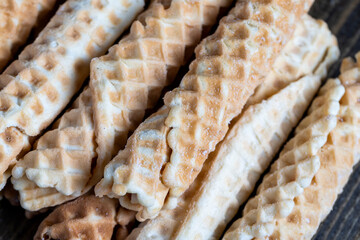 thin crispy waffles lie on a black table