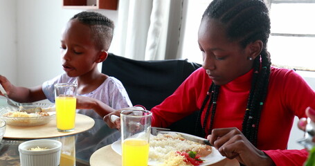 Black children eating lunch at home, African mixed race kids at meal time