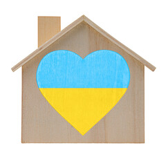 Wooden house model with a heart in  the colors of the flag of Ukraine. Isolated on white background. No war, stop war.