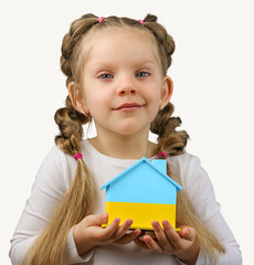 The little girl calls to Stop war, holding wooden house model in the colors of the flag of Ukraine. Grey background. No war. Stop war.