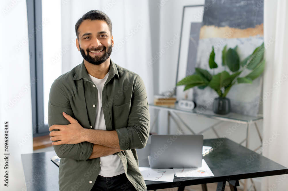 Wall mural portrait of a successful confident indian man, creative manager, it specialist, designer, wearing ca