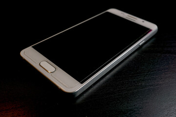 White smartphone on a black table