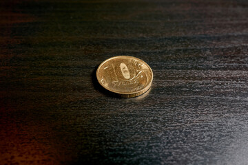 Golden coins of ten rubles on a black table