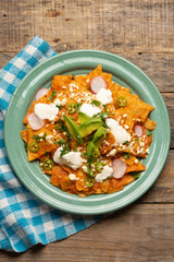 Red chilaquiles with cheese and avocado. Mexican food