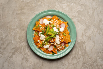 Red chilaquiles with cheese and avocado. Mexican food