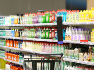 choosing detergents, toilet paper in supermarket.empty grocery cart in an empty supermarket