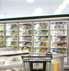 choosing a dairy products at supermarket.empty grocery cart in an empty supermarket