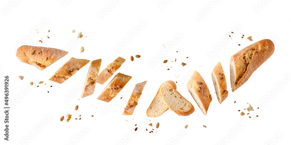 Wall mural cutting fresh baked loaf wheat baguette bread with crumbs and seeds flying isolated on white backgro