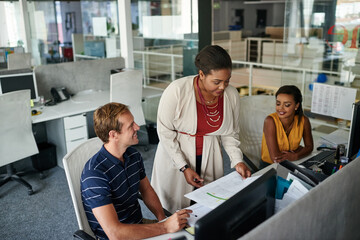Teaming up for success. Shot of three colleagues having a meeting in an office.