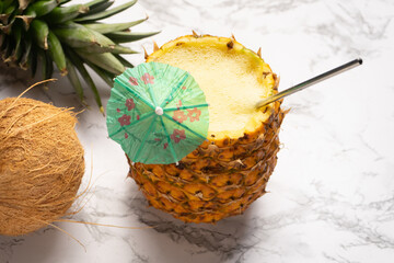 Pina colada cocktail with umbrella and coconut
