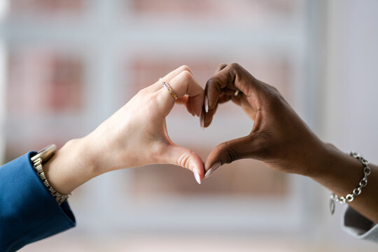Multiracial Female Friend's Hands Showing Heart