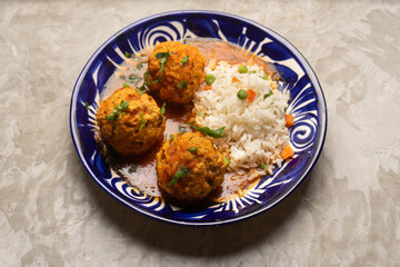 Meatballs with chipotle red sauce and rice. Mexican food