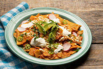 Red chilaquiles with cheese and avocado. Mexican food