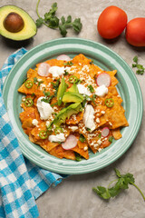 Red chilaquiles with cheese and avocado. Mexican food