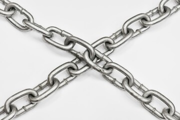 Fototapeta premium Old metal chain cross on white background. Concept of imprisonment, incarceration, detention, ban, isolation, lock.