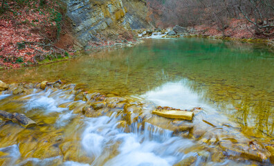 small mountain river with waterfall in mountain canyon, autumn outdoor mountain scene