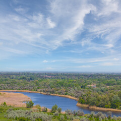 Obraz premium view ftom above to quiet river flow through a forest, summer natural countryside scene