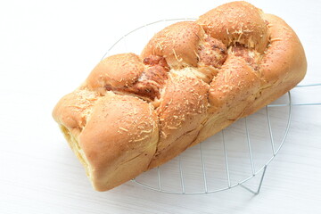 Big bread with cheese, grated parmesa cheese on white wooden background