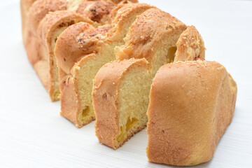 Big bread with cheese, grated parmesa cheese on white wooden background