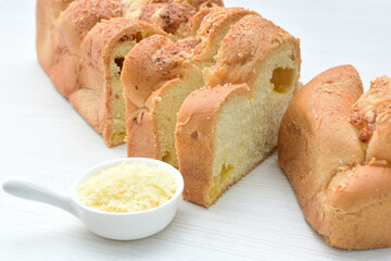 Big bread with cheese, grated parmesa cheese on white wooden background