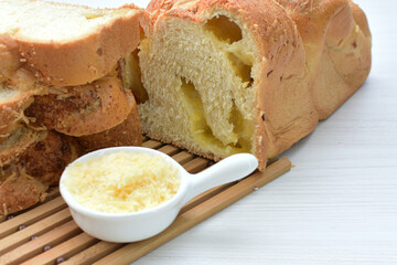 Big bread with cheese, grated parmesa cheese on white wooden background