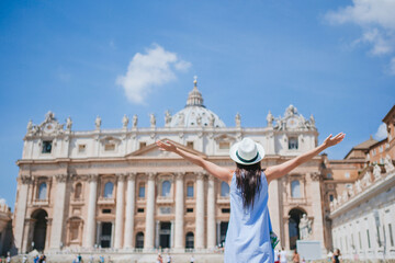 Happy young woman in Vatican city and St. Peter's Basilica church, Rome, Italy.