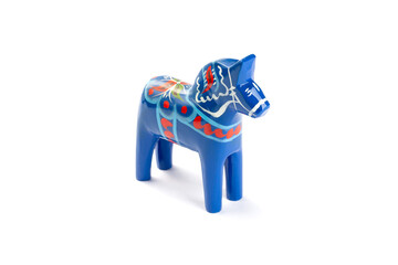 Swedish traditional souvenir wooden Dala or Dalecarlian horse, blue colored, isolated on white, side