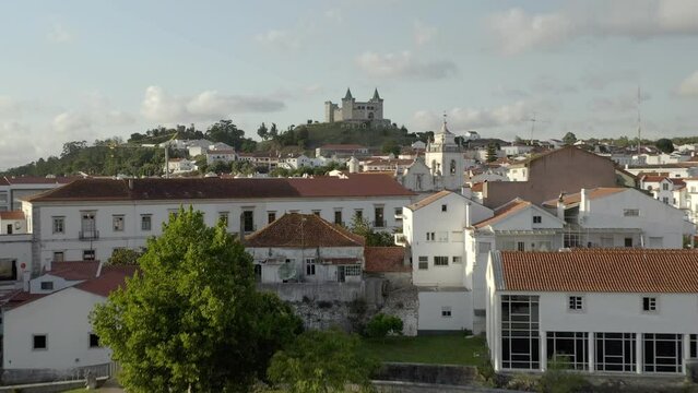 Porto de Mos cityscape and amazing colorful castle drone aerial view with iconic green towers at sunset, in Portugal