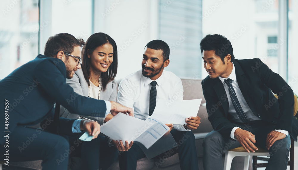 Canvas Prints We think wiser when were together. Shot of a group of businesspeople discussing paperwork while sitting together.