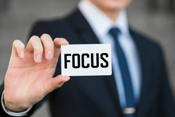Man showing paper with FOCUS text