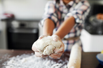 Shaping made fun. Cropped shot of an unrecognizable girl having fun while baking in the kitchen at home.
