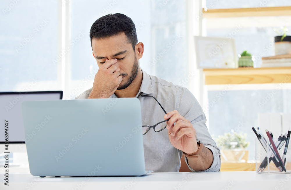 Canvas Prints I think its time to take a break. Shot of a young man having a headache at work in a modern office.