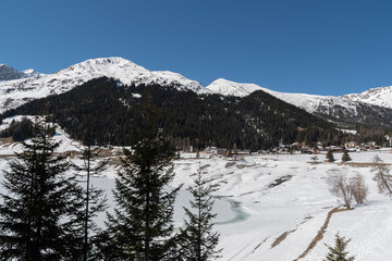 Fototapeta na wymiar View over the frozen lake in Davos in Switzerland