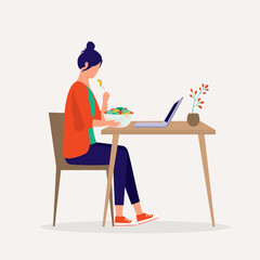 Side View Of A Young Woman Sitting At Dining Table Eating Fresh Salad While Looking At Her Laptop.