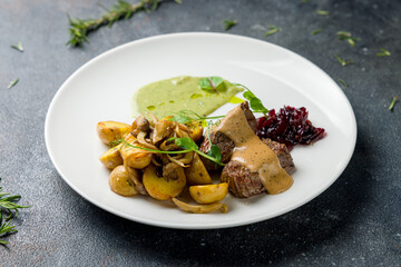 medallions of beef with fried potatoes with mushrooms and jam of onion