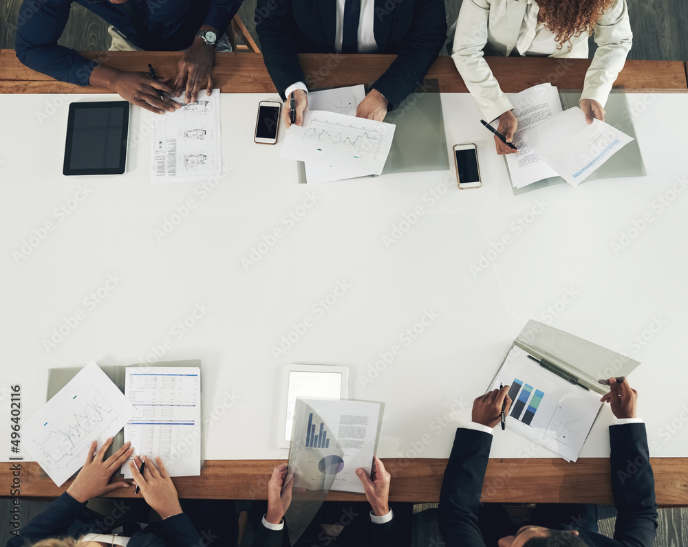 Poster looking at ways to upgrade the business. high angle shot of a team of businesspeople working around 