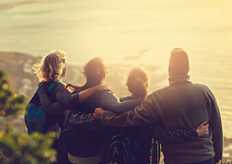 The reward is worth the work. Shot of a group of friends on a mountain top.