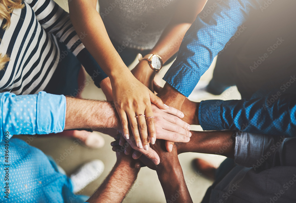 Aufkleber Getting it done through teamwork. Shot of a group of creative businesspeople standing with their hands in a huddle.