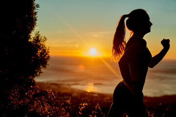 Running towards her goal. Cropped shot of a young woman running in the early morning.