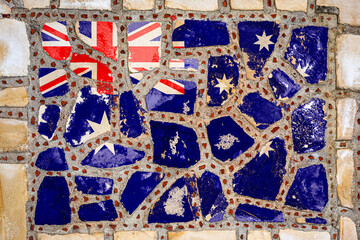 Fototapeta na wymiar National flag of New Zealand on stone wall background. Flag banner on stone texture background.