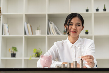 Preset Money Saving Ideas by female hand put a coin on the pile for Save money for future investment ideas.